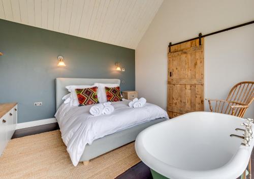 um quarto com uma cama com toalhas em The Old School House em Wickhambrook