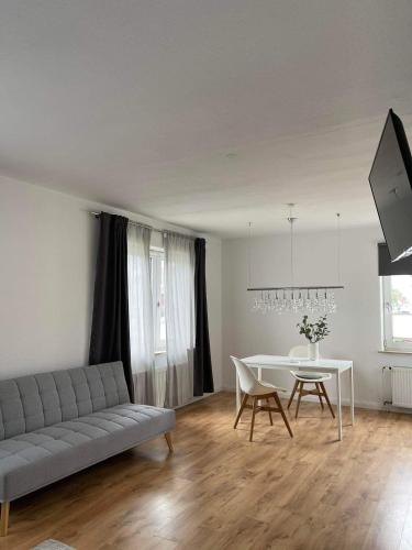 a living room with a couch and a table at DEICHHÜTTE NORDDEICH in Norddeich
