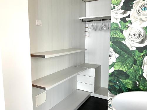 a white walk in closet with white shelves at Grand Apartment Sissi in Trieste
