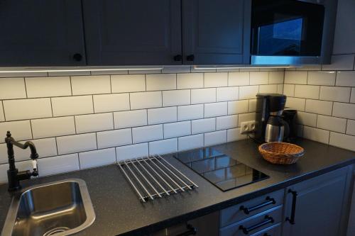 a kitchen with blue cabinets and a sink and a counter top at Appartement Schmid in Oetz