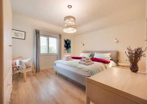 a bedroom with a bed with pillows on it at Rose Cottage in Middleton