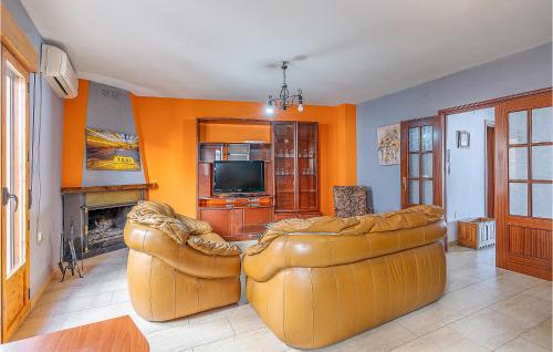 a living room with two leather couches and a television at Cozy Home In Torres With Wifi in Torres