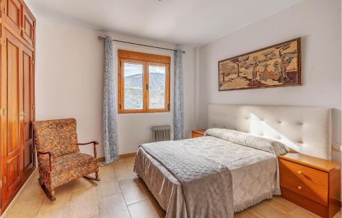 a bedroom with a bed and a chair and a window at Cozy Home In Torres With Kitchenette in Torres