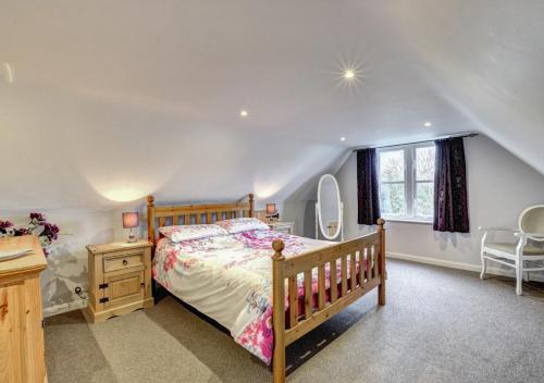 a bedroom with a bed and a desk and a window at Barn Owl Retreat Sibton in Sibton