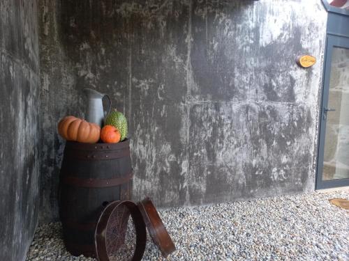 a bowl of fruit and a vase on a barrel at Quinta do ribeiro in Arcos de Valdevez