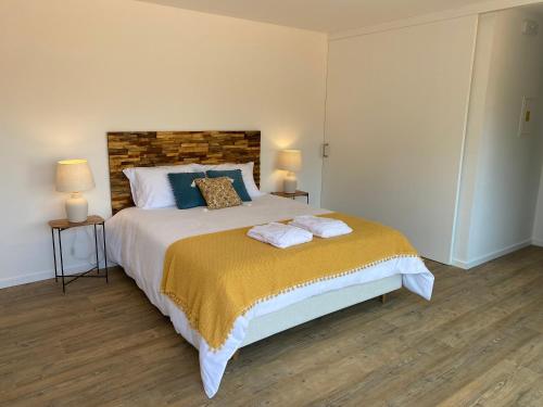 a bedroom with a bed with two towels on it at Quinta do ribeiro in Arcos de Valdevez