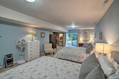 a bedroom with two beds and a desk with a fan at Lovely Snohomish Studio Near Boating and Hiking in Snohomish
