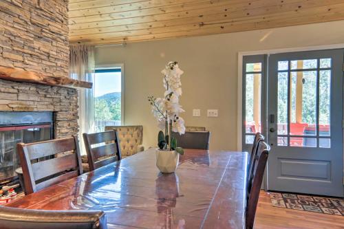 a dining room with a table and a fireplace at Pine Mountain Club Home with Beautiful View! in Frazier Park