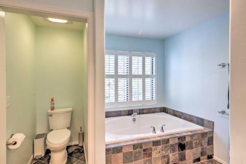 a bathroom with a toilet and a bath tub at Pine Mountain Club Home with Beautiful View! in Frazier Park