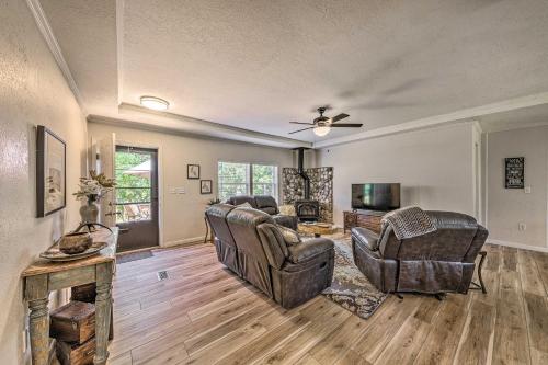 a living room with leather chairs and a television at Peaceful Alto Home with Deck about 12 Mi to Ski Apache! in Alto