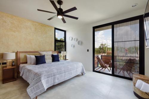 ein Schlafzimmer mit einem Bett und einem Deckenventilator in der Unterkunft Luxury Villas in Aldea Zama in Tulum