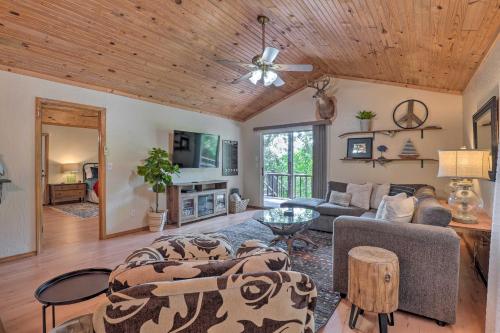 a living room with a couch and a table at Lush Garfield Cabin with Community Pool and Lake! in Garfield