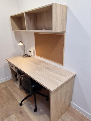an office with a desk with a chair and shelves at Micampus Leganés Student Residence in Leganés