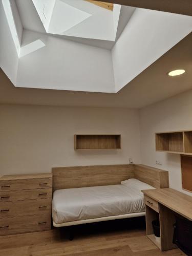 a bedroom with a bed and a desk at Micampus Leganés Student Residence in Leganés