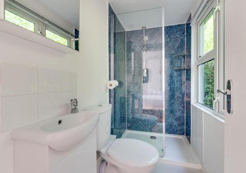 a bathroom with a toilet and a sink and a tub at The Studio in Waldringfield