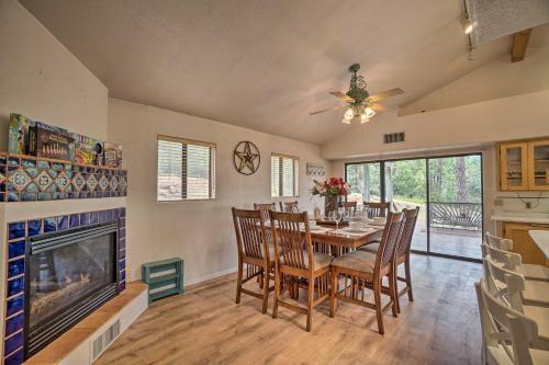 a dining room with a table and a fireplace at Cozy Pine Retreat with Private Hot Tub and Views in Pine