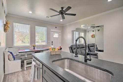 a kitchen with a sink and a living room at Bright Amarillo Townhome Near Parks and Town! in Amarillo