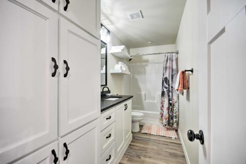 a white bathroom with a sink and a toilet at Bright Amarillo Townhome Near Parks and Town! in Amarillo