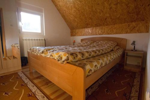 a bedroom with a bed in a room with a window at Guest House Happy in Žabljak