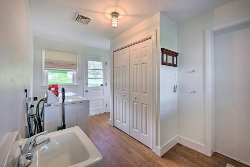 a bathroom with a sink and a white door at Cozy Kinzers Getaway with Furnished Deck, Grill 