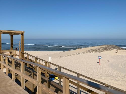 a wooden boardwalk leading to a beach with the ocean at Torreira Vacation Homes - Sea House in Torreira