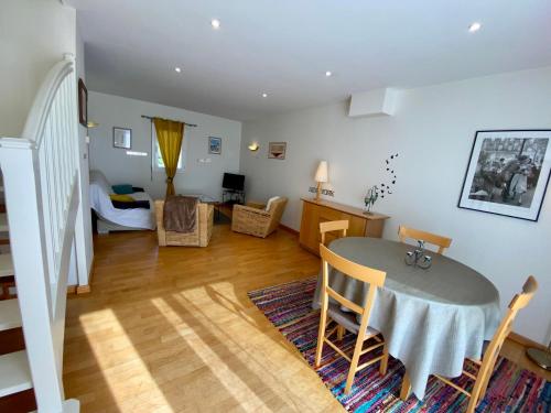 a kitchen and living room with a table and chairs at Résidence De La Rance in La Richardais