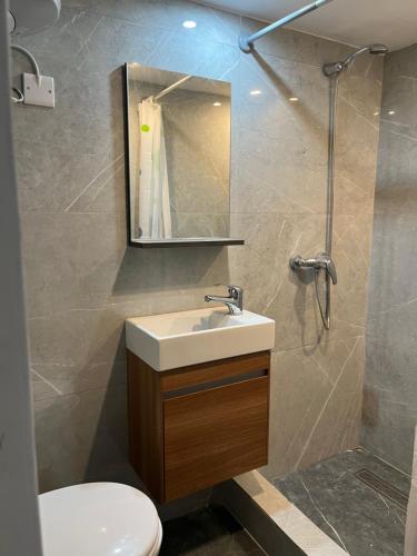 a bathroom with a sink and a toilet and a mirror at Traditional Townhouse In The Hearth Of Valletta in Valletta