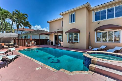 a swimming pool in front of a house at Spacious Miami Retreat with Grill, Pool and Dock! in Miami
