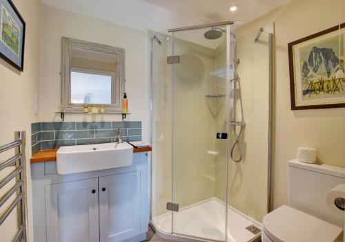 a bathroom with a sink and a shower at Garden Cottage The Old Mill in Snape