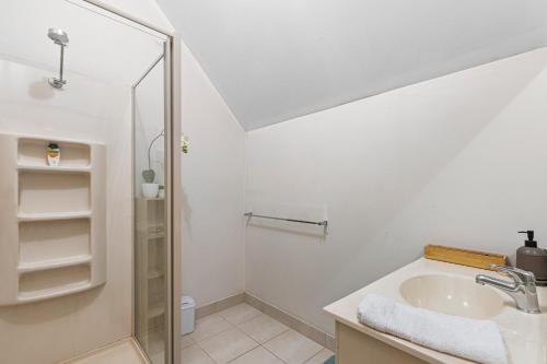 a white bathroom with a sink and a shower at Morningside farm house with Mountian views... in Wartook