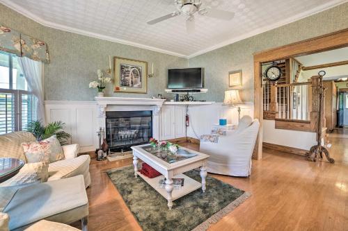 a living room with a couch and a fireplace at Elegant 1905 Home Steps to Torch Lake and Dtwn in Alden