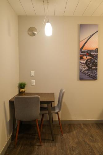 a dining room table with a chair and a painting at Americana Modern Hotel in Redding