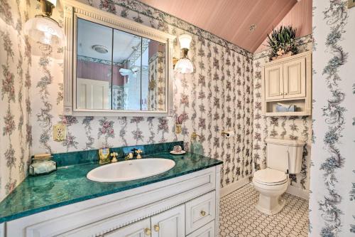 a bathroom with a sink and a toilet at Elegant 1905 Home Steps to Torch Lake and Dtwn in Alden