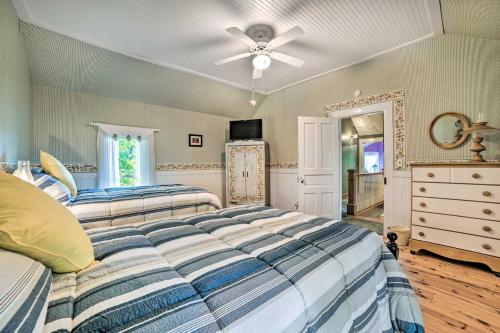 a bedroom with two beds and a ceiling fan at Elegant 1905 Home Steps to Torch Lake and Dtwn in Alden