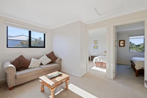 a living room with a couch and a table at Beaches on Church in Cowes