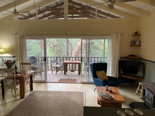 a living room with a view of a deck at Rustic Spirit in Bilpin