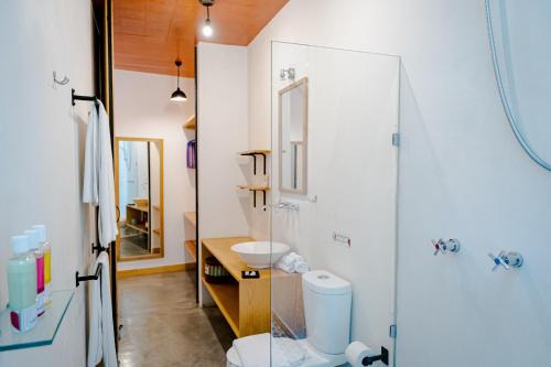 a bathroom with a shower and a toilet and a sink at Hotel con Corazón in Oaxaca City