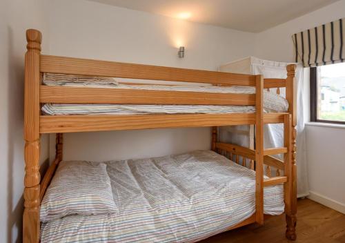 a couple of bunk beds in a room at 248 Cae Du in Abersoch