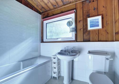 a bathroom with a sink and a toilet and a window at 20 Timber Hill in Haverfordwest