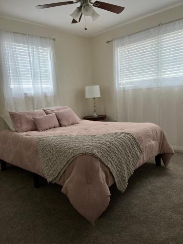a bedroom with a large bed with a ceiling fan at Gaia House in Annapolis