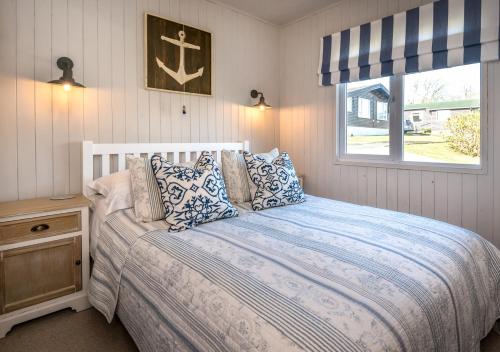 a bedroom with a large bed with a window at 9 Braich Farm in Llanengan