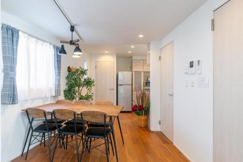 a kitchen and dining room with a wooden table and chairs at SHIBUYA TOKYO in Tokyo