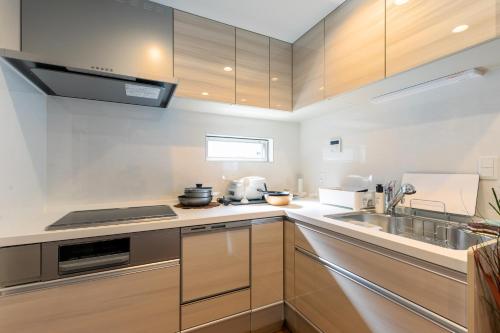 a kitchen with wooden cabinets and a sink at SHIBUYA TOKYO in Tokyo
