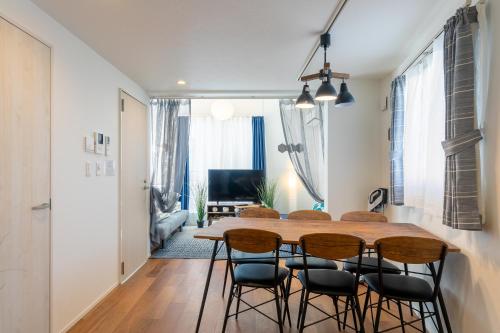 a kitchen and dining room with a wooden table and chairs at SHIBUYA TOKYO in Tokyo