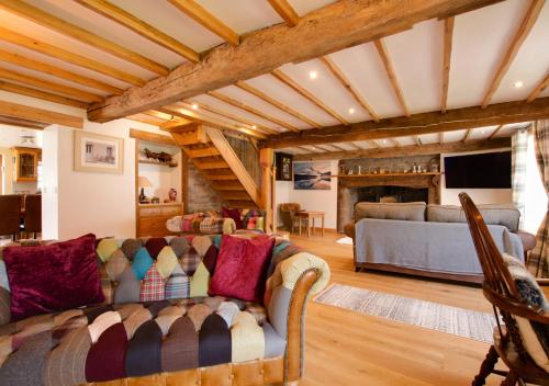 a living room with a couch and a fireplace at Bedlwyn Coch Farm in Cray