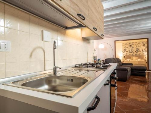 a kitchen with a sink and a stove at Dimore Castello in Cagliari