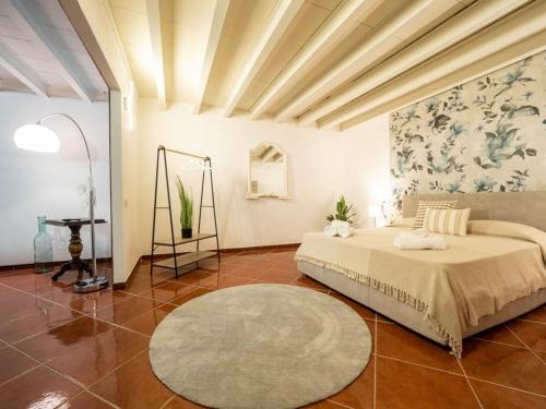 a large bedroom with a bed and a rug at Dimore Castello in Cagliari