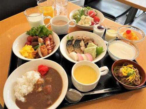 a tray with plates of food on a table at Green Rich Hotel Yamaguchi Yuda Onsen in Yamaguchi