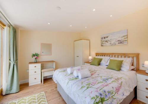 a bedroom with a large bed with two pillows at Beudy Bach in Llanrwst