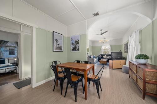 a dining room and living room with a table and chairs at Giants Table and Cottages in Maydena